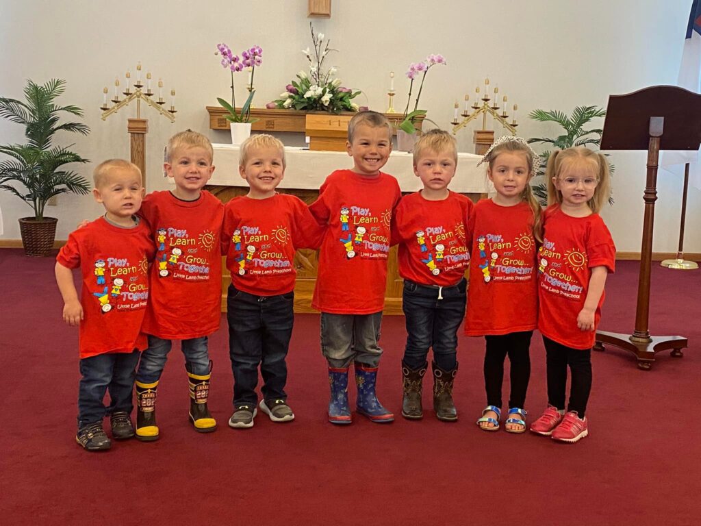 Preschool students wearing matching shirts in the sanctuary