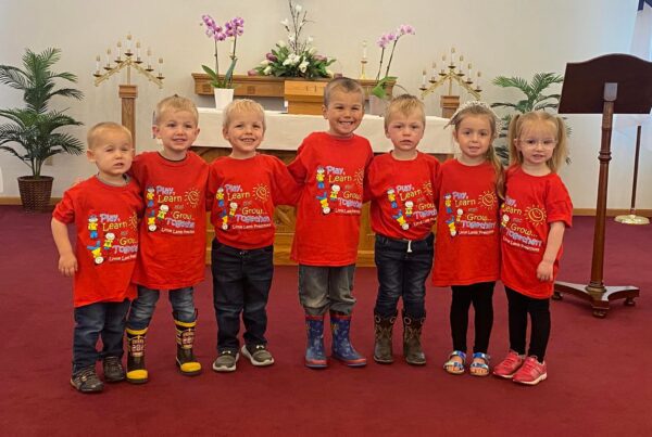 Preschool students wearing matching shirts in the sanctuary